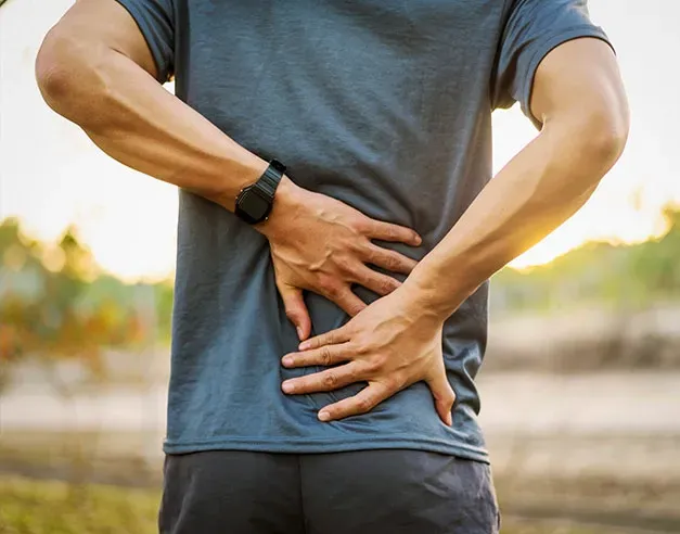 A man holding his lower back in pain